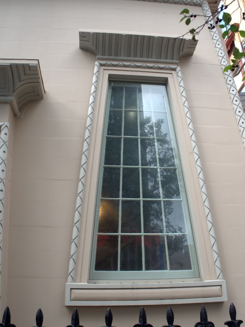 The trapezoid shape of the windows is characteristic of the Egyptian Revival style