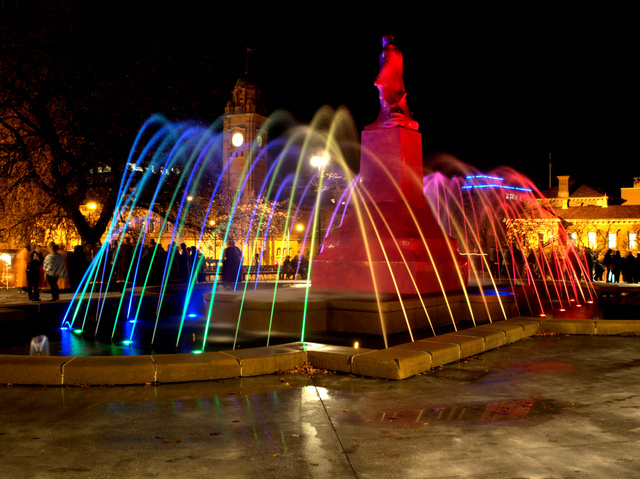 Rainbow fountain at Franklin Square, with plastic-wrapped statue of Sir John