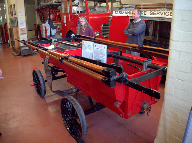 An early fire fighting vehicle was pulled and operated by convict labour. A similar vehicle, without the bright red paint job, is held in the collection at the Port Arthur Historic Site.
