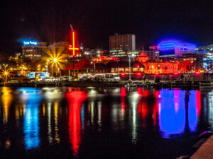 Hobart’s skyline reflected in its historic waterfront. The red lighted buildings and inverted crosses were a feature of this year’s Dark Mofo midwinter festival.