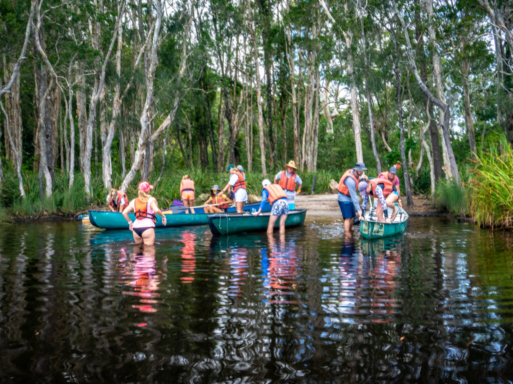 Getting into the Canadian-style kayaks for the paddle upstream