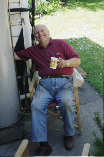 Dad celebrating the successful installation of a new water cylinder