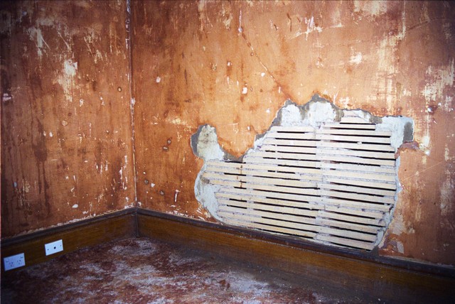 Damp had caused large areas of plaster to fail in the lounge room