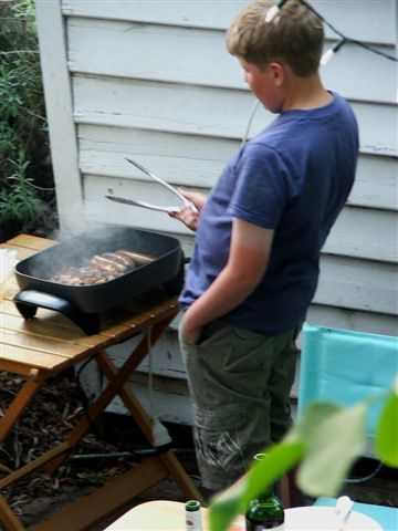 Alexander some years later, on the tongs, cooking the snags