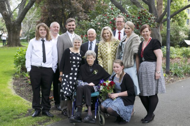 Mum in a wheelchair with her family at Kiri and Tony's wedding in 2013
