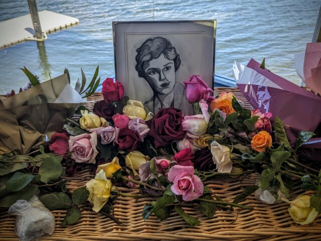 Mum's casket was covered in flowers, many picked this morning from our own gardens. The portrait of mum is by her granddaughter, Harriette.